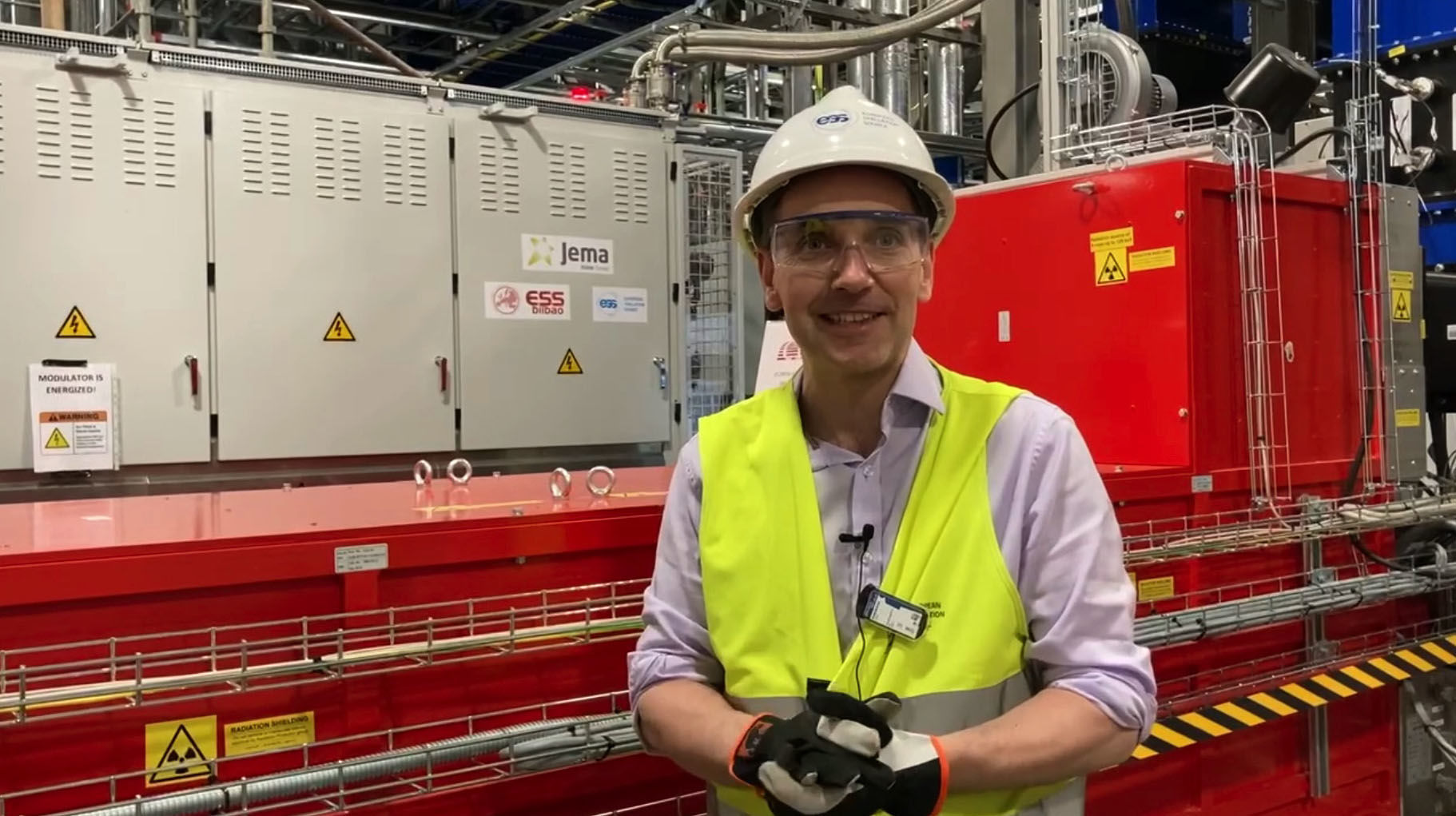 RF group leader, Morten Jensen standing in front of  klystron in the Klystron Gallery in the ESS Accelerator buildings.