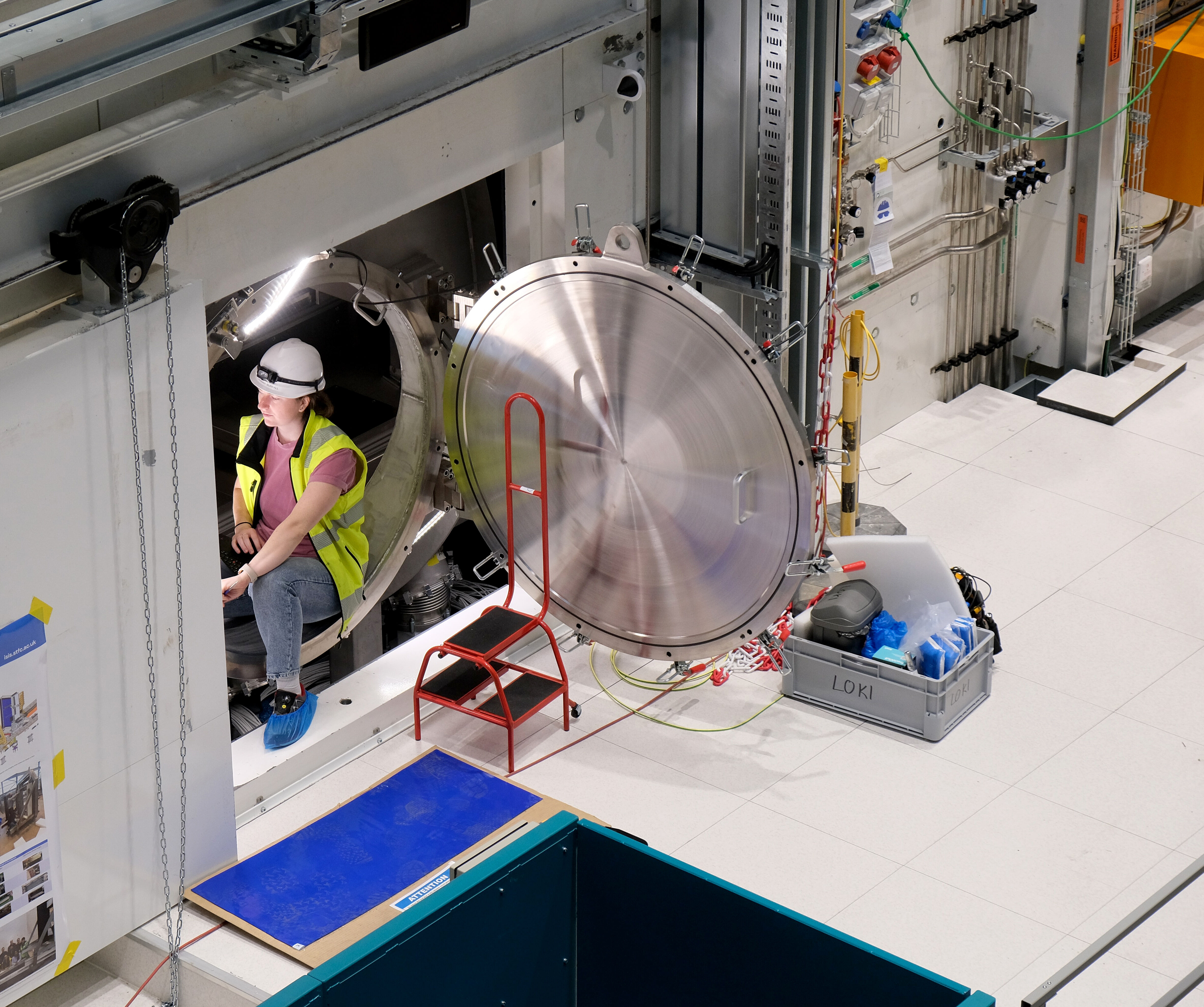 An engineer sits inside the LoKI detector tank