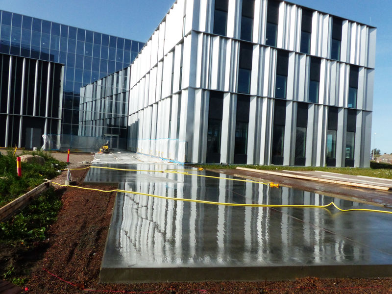 Outdoor concrete floors are cast for the ESS Campus area.